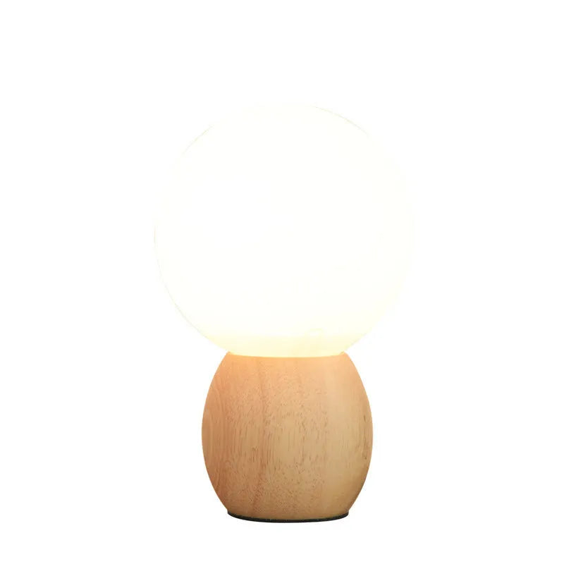Nordic style glass ball table lamp with large glass shade and LED light source on table