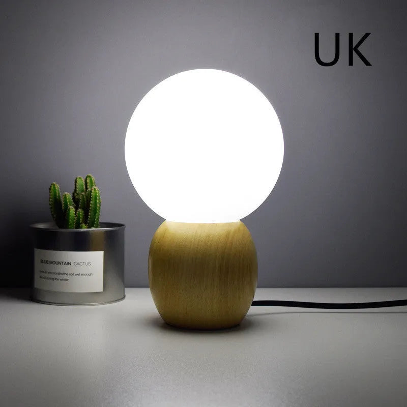 Nordic style glass ball table lamp with large glass shade and LED light source on table