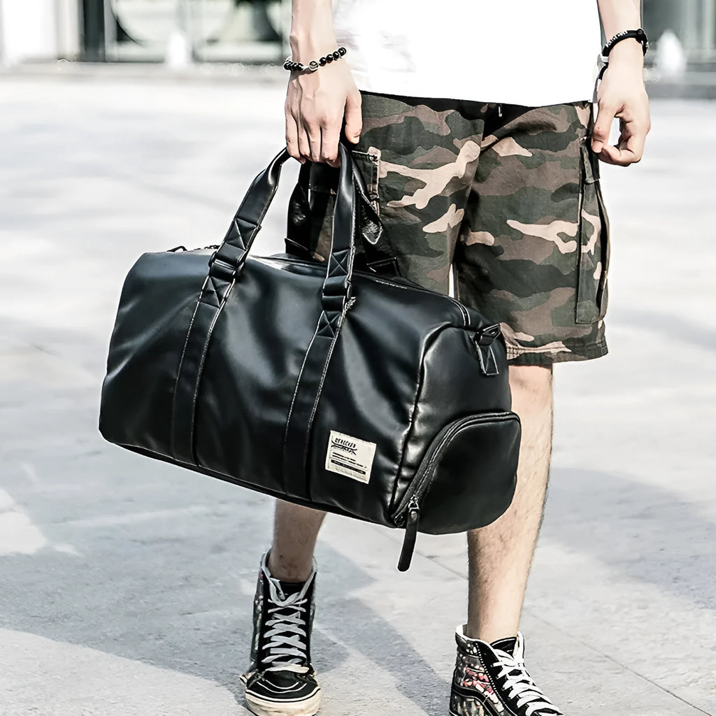 Black large capacity PU leather waterproof sports gym bag with multiple internal pockets and handles.
