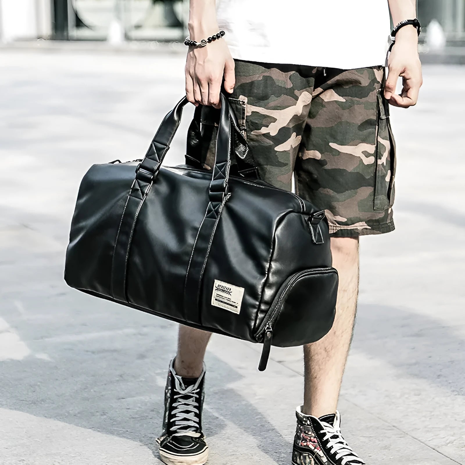 Black large capacity PU leather waterproof sports gym bag with multiple internal pockets and handles.