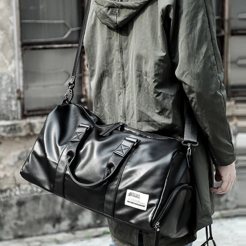 Black large capacity PU leather waterproof sports gym bag with multiple internal pockets and handles.