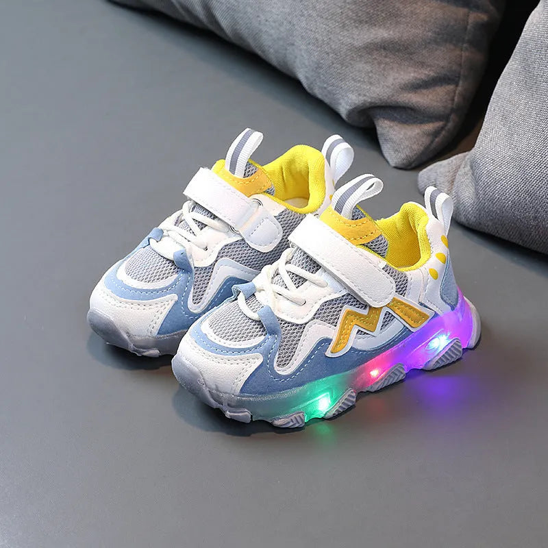 Kids' black, grey, and pink sneakers with Velcro strap and breathable mesh upper on a rubber sole.