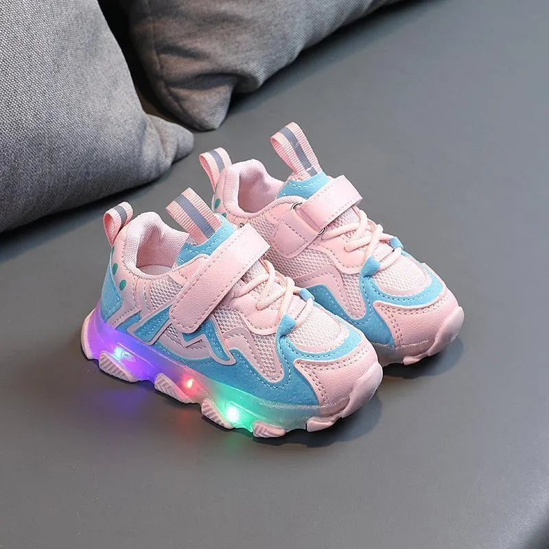 Kids' black, grey, and pink sneakers with Velcro strap and breathable mesh upper on a rubber sole.