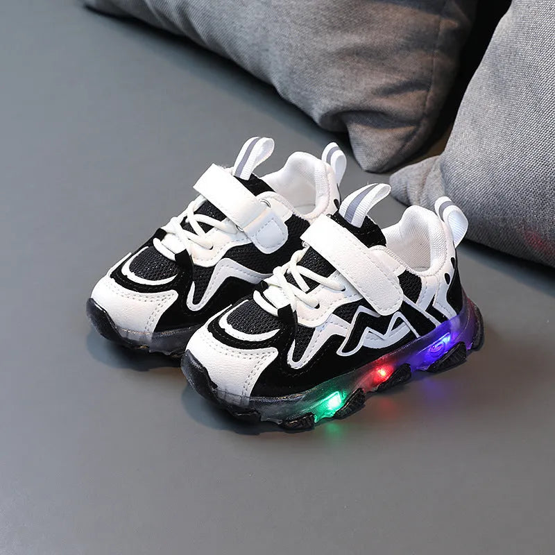Kids' black, grey, and pink sneakers with Velcro strap and breathable mesh upper on a rubber sole.