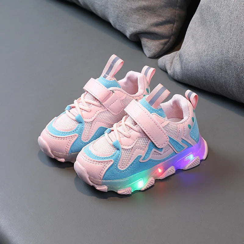 Kids' black, grey, and pink sneakers with Velcro strap and breathable mesh upper on a rubber sole.