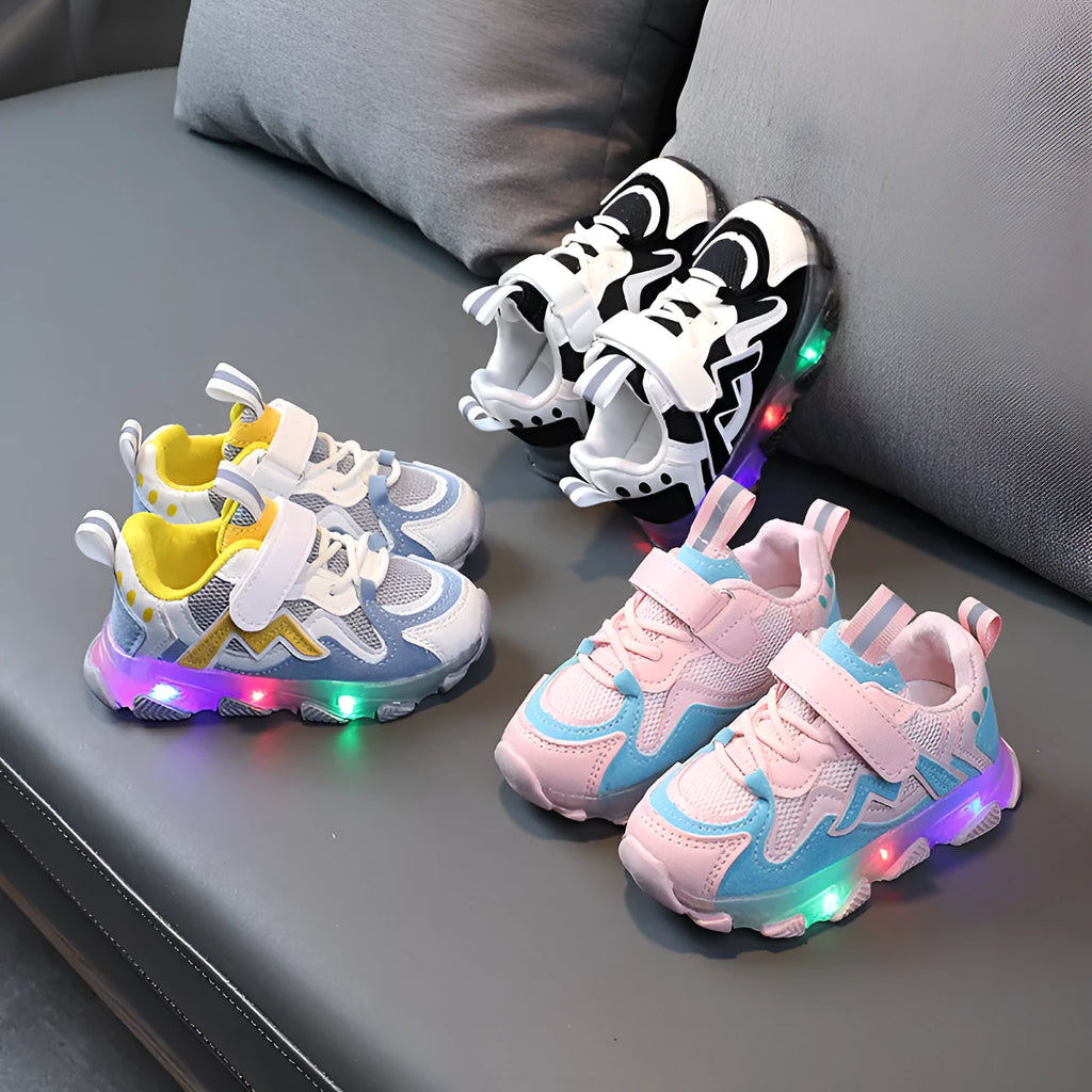 Kids' black, grey, and pink sneakers with Velcro strap and breathable mesh upper on a rubber sole.
