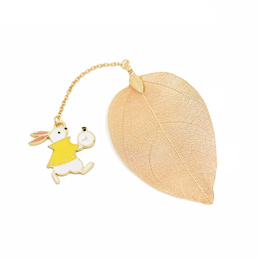 KC alloy bookmark with Alice, rabbit, clock, and leaf charms on kraft packaging