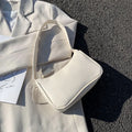 Women's one-shoulder armpit bag in PU leather with zipper closure and colour contrast design, medium size