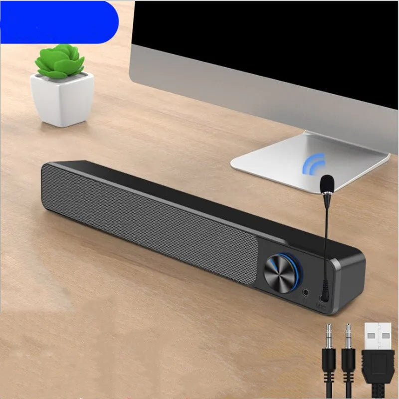 Black and white G18 compact desktop computer speaker with USB cable on a wooden desk.