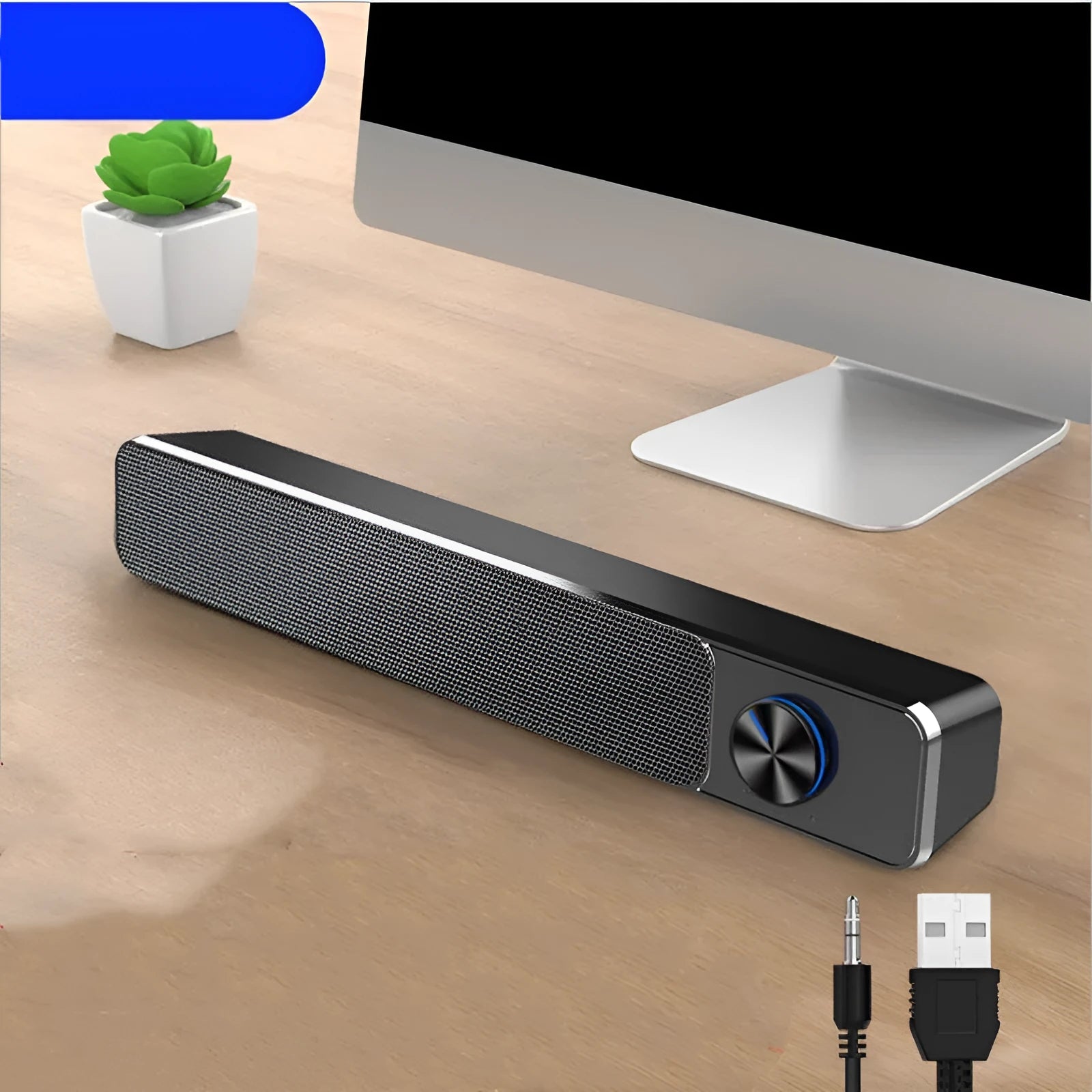 Black and white G18 compact desktop computer speaker with USB cable on a wooden desk.
