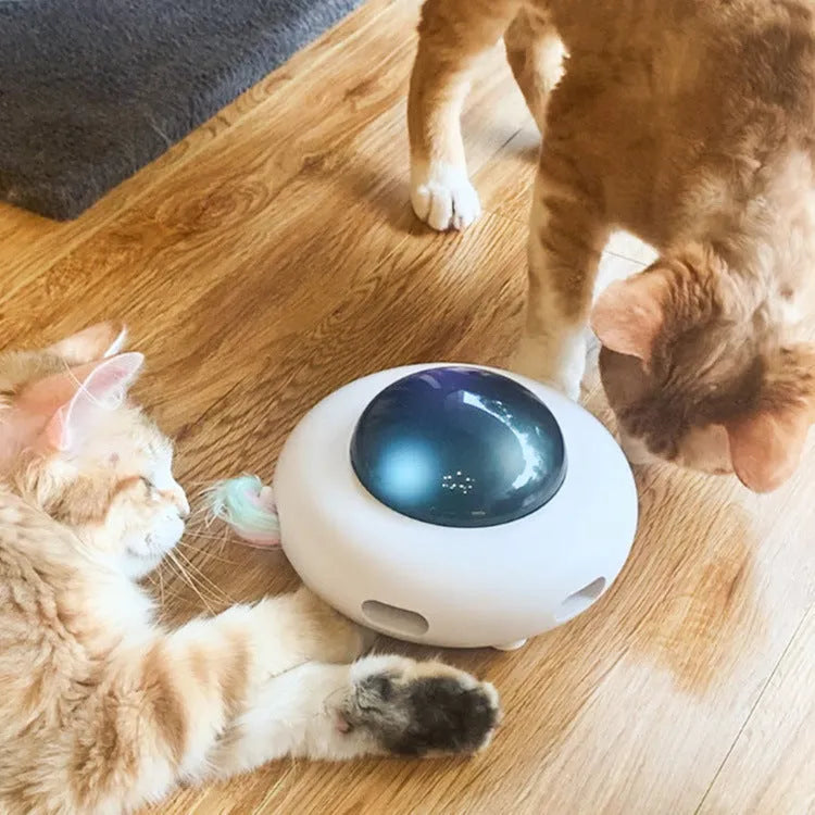 UFO electric cat toy with vibration activation, showing UFO body, feathers, and cleaning rings on a surface