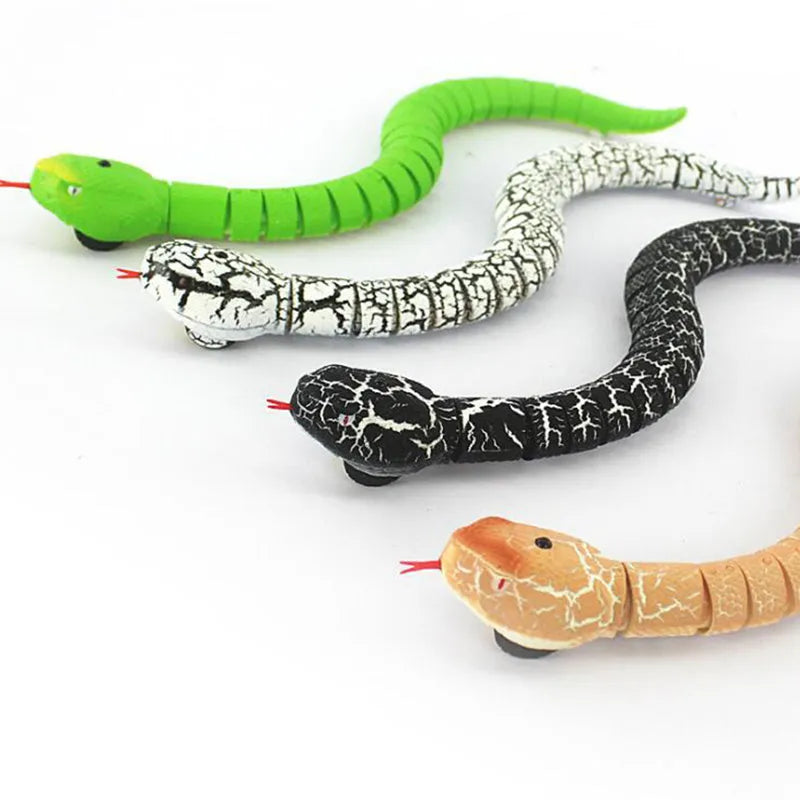 Black and grey cobra snake toy robot with remote control, USB charging cable, and batteries