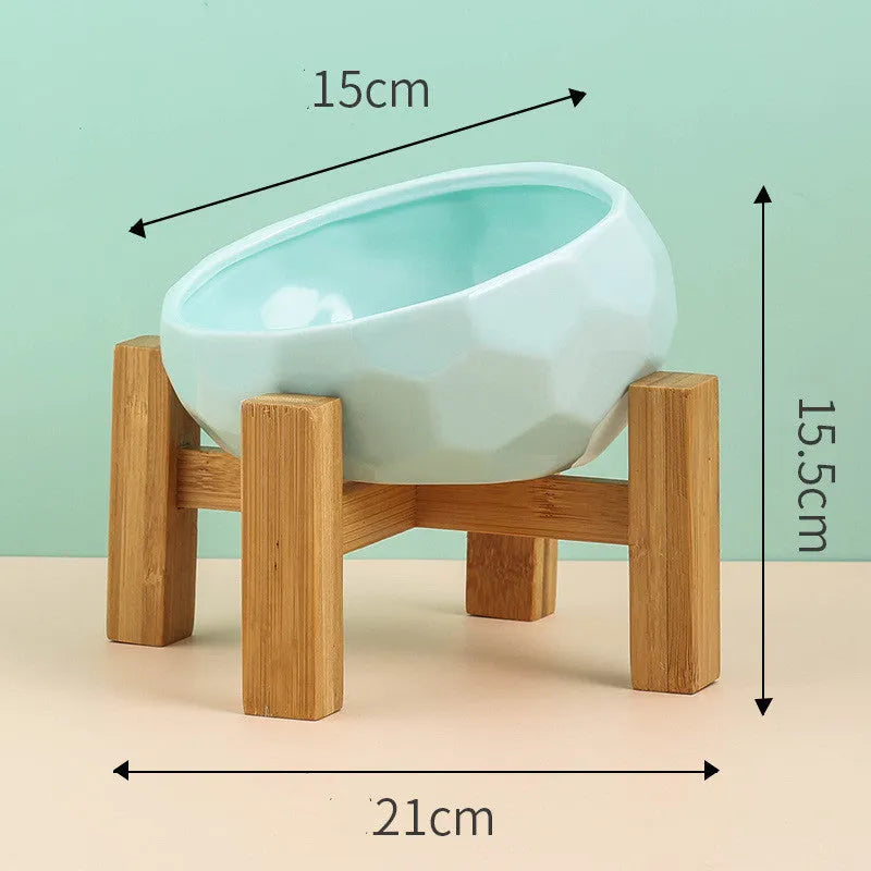 Ceramic cat bowl with oblique mouth design in white colour option on a surface