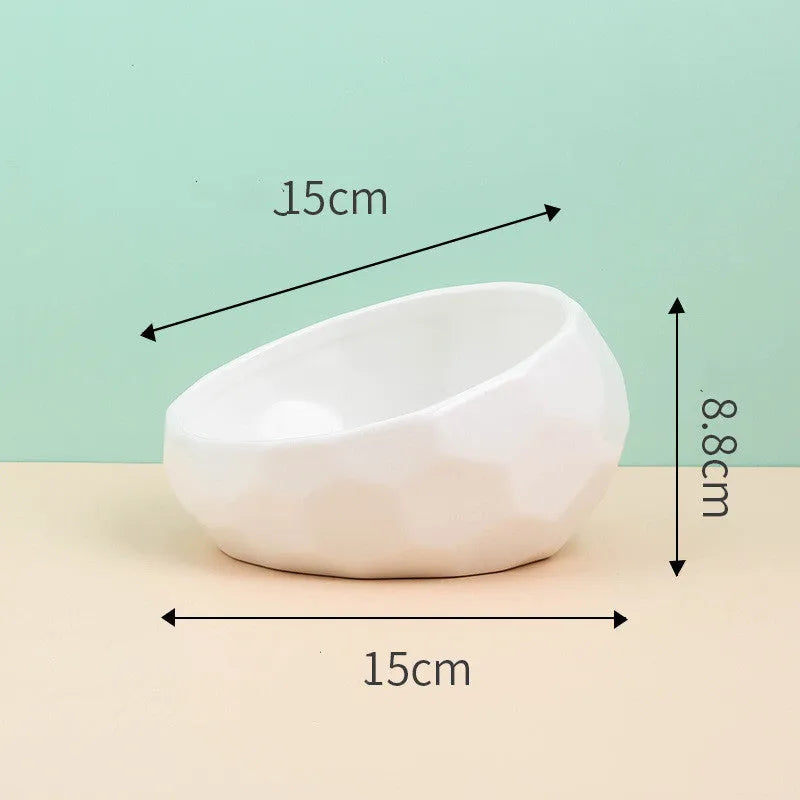 Ceramic cat bowl with oblique mouth design in white colour option on a surface