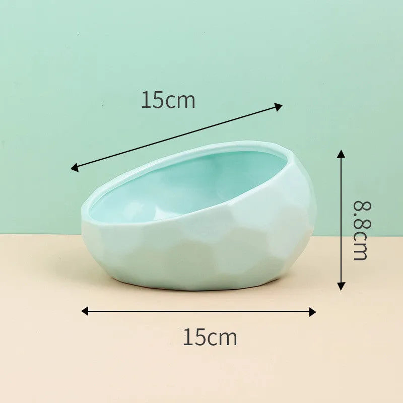 Ceramic cat bowl with oblique mouth design in white colour option on a surface