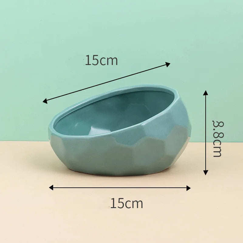 Ceramic cat bowl with oblique mouth design in white colour option on a surface