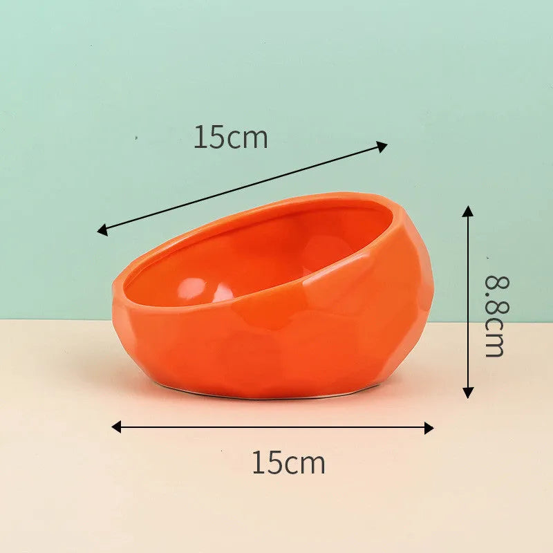 Ceramic cat bowl with oblique mouth design in white colour option on a surface
