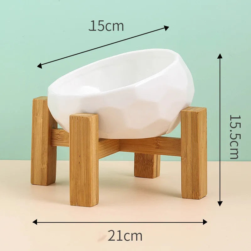 Ceramic cat bowl with oblique mouth design in white colour option on a surface