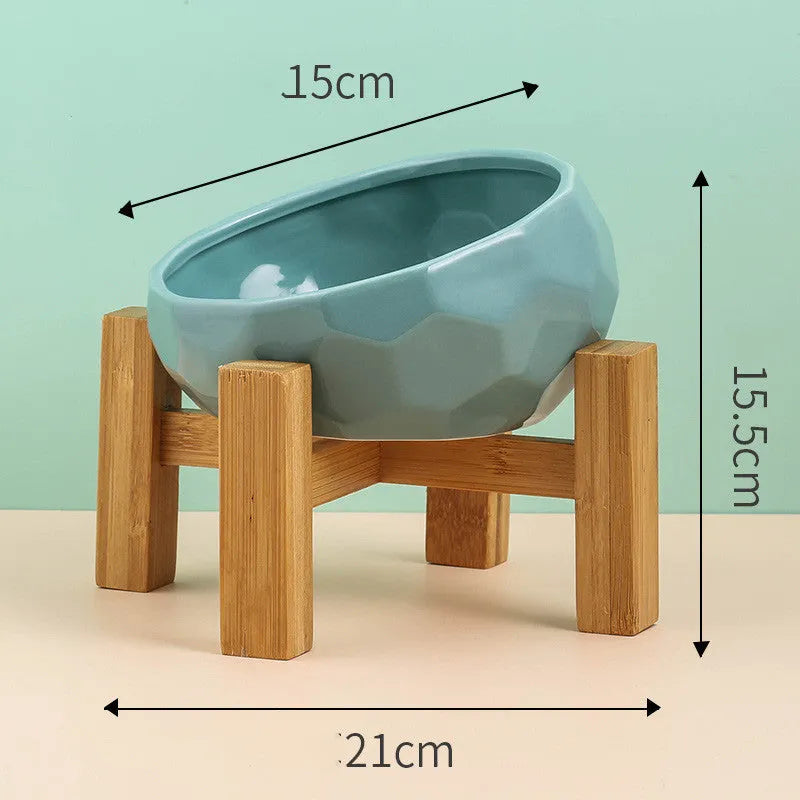 Ceramic cat bowl with oblique mouth design in white colour option on a surface