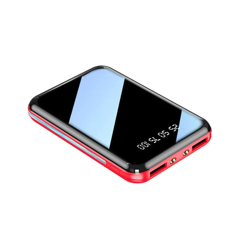 30000mAh mini portable power bank in black with dual USB output ports on a wooden surface