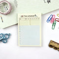 A5 weekly monthly work plan diary notebook open showing one of four design style layouts.