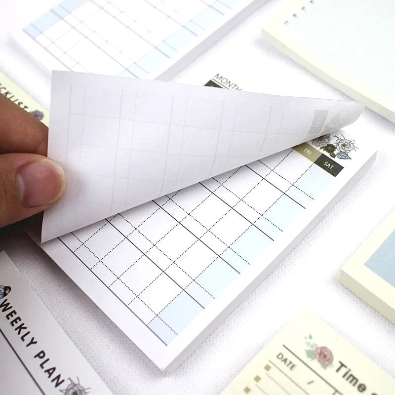 A5 weekly monthly work plan diary notebook open showing one of four design style layouts.