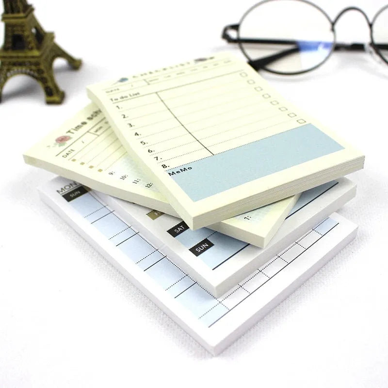 A5 weekly monthly work plan diary notebook open showing one of four design style layouts.