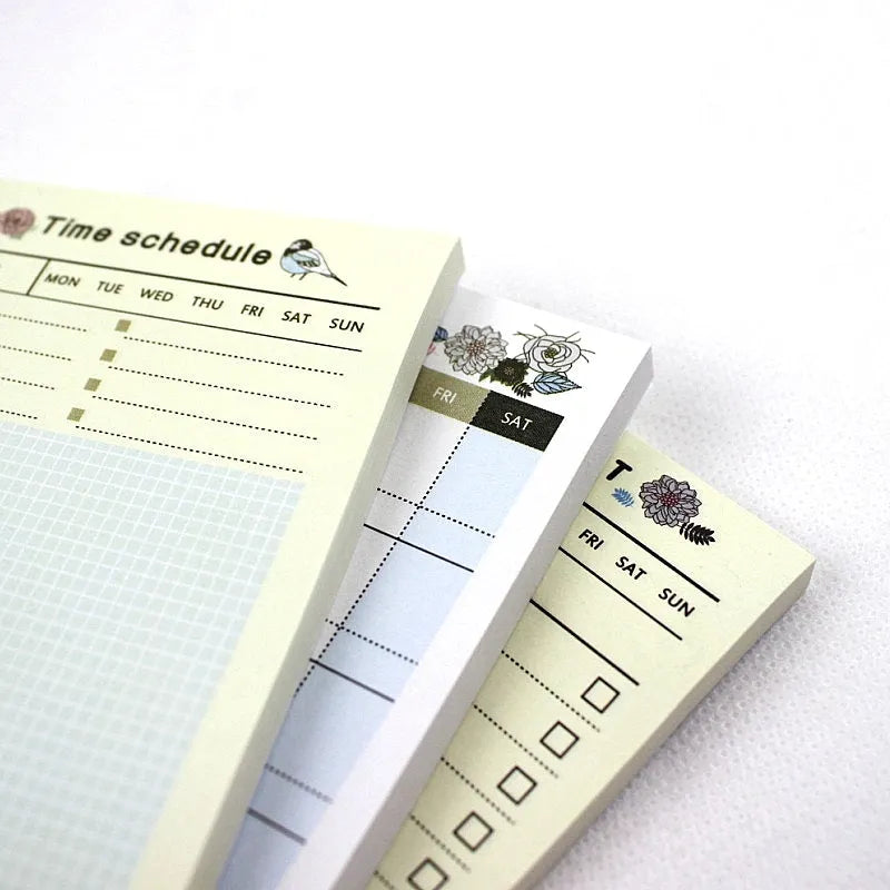 A5 weekly monthly work plan diary notebook open showing one of four design style layouts.