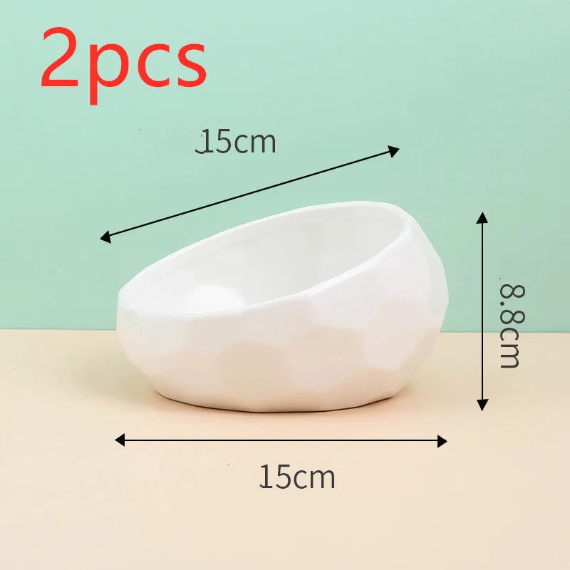 Ceramic cat bowl with oblique mouth design in white colour option on a surface
