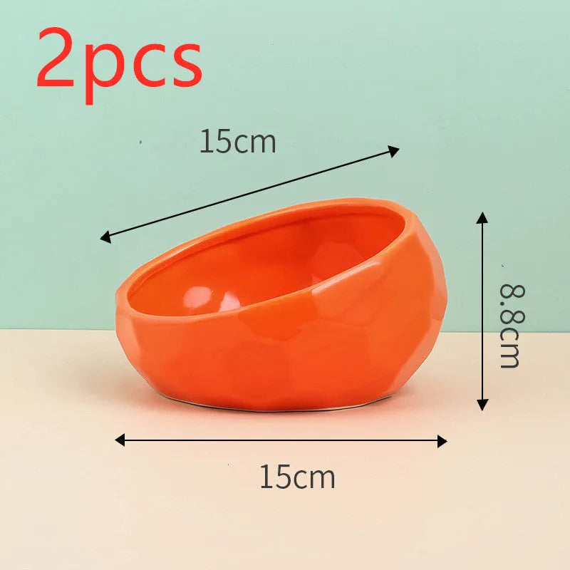 Ceramic cat bowl with oblique mouth design in white colour option on a surface