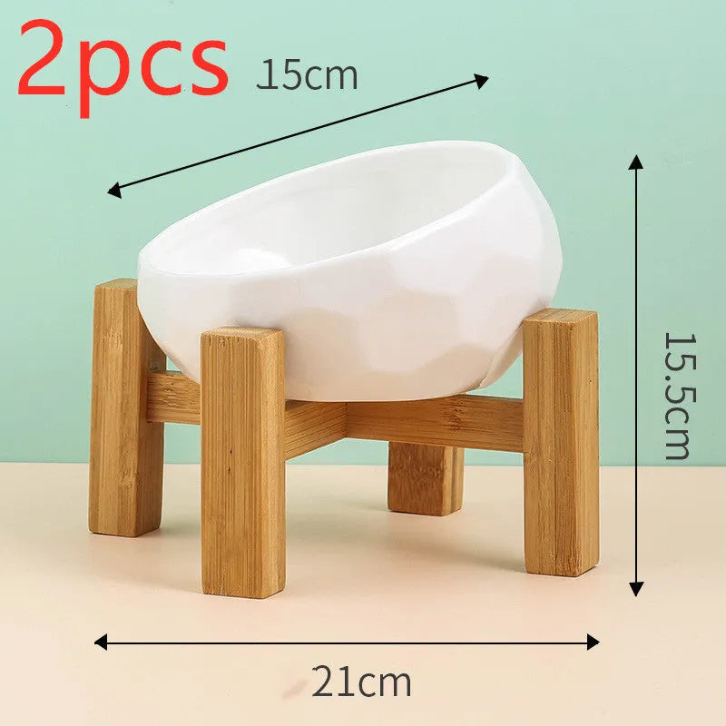 Ceramic cat bowl with oblique mouth design in white colour option on a surface