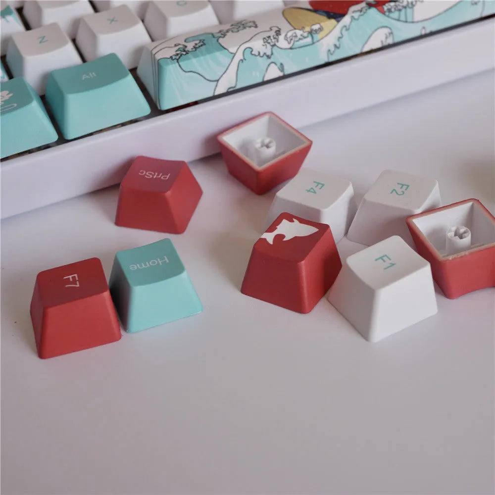 Coral Sea 108 keycap set for mechanical keyboard with blue gradient keys and multimedia legends on a white desk