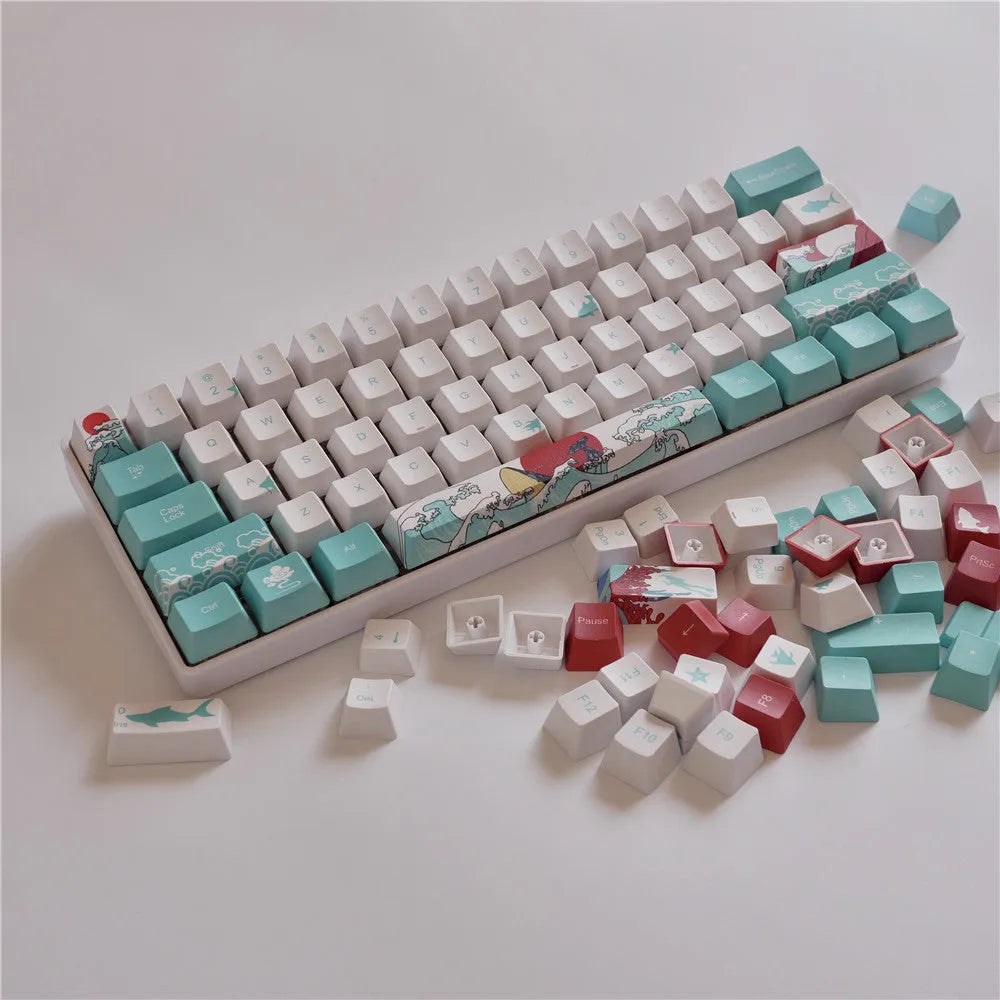 Coral Sea 108 keycap set for mechanical keyboard with blue gradient keys and multimedia legends on a white desk