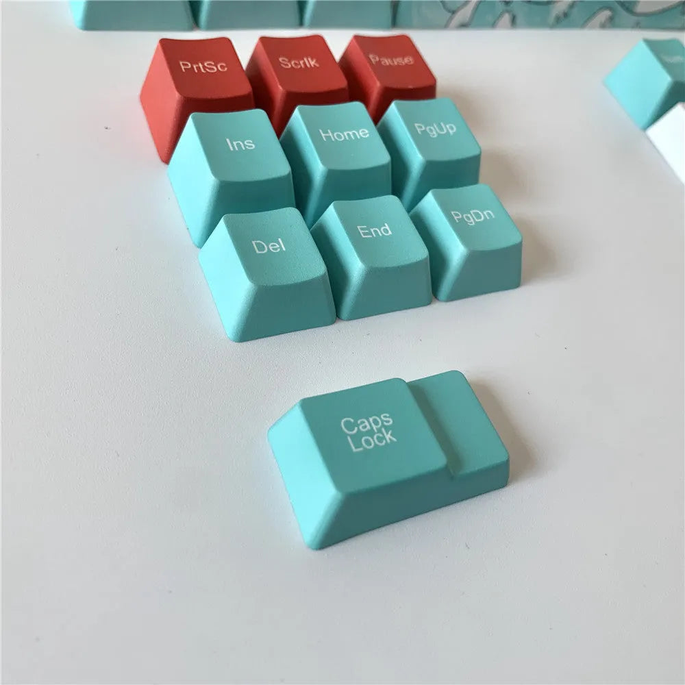 Coral Sea 108 keycap set for mechanical keyboard with blue gradient keys and multimedia legends on a white desk