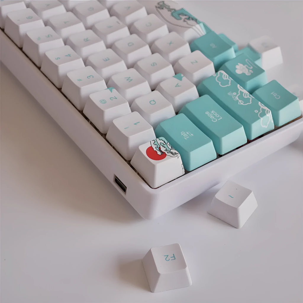Coral Sea 108 keycap set for mechanical keyboard with blue gradient keys and multimedia legends on a white desk