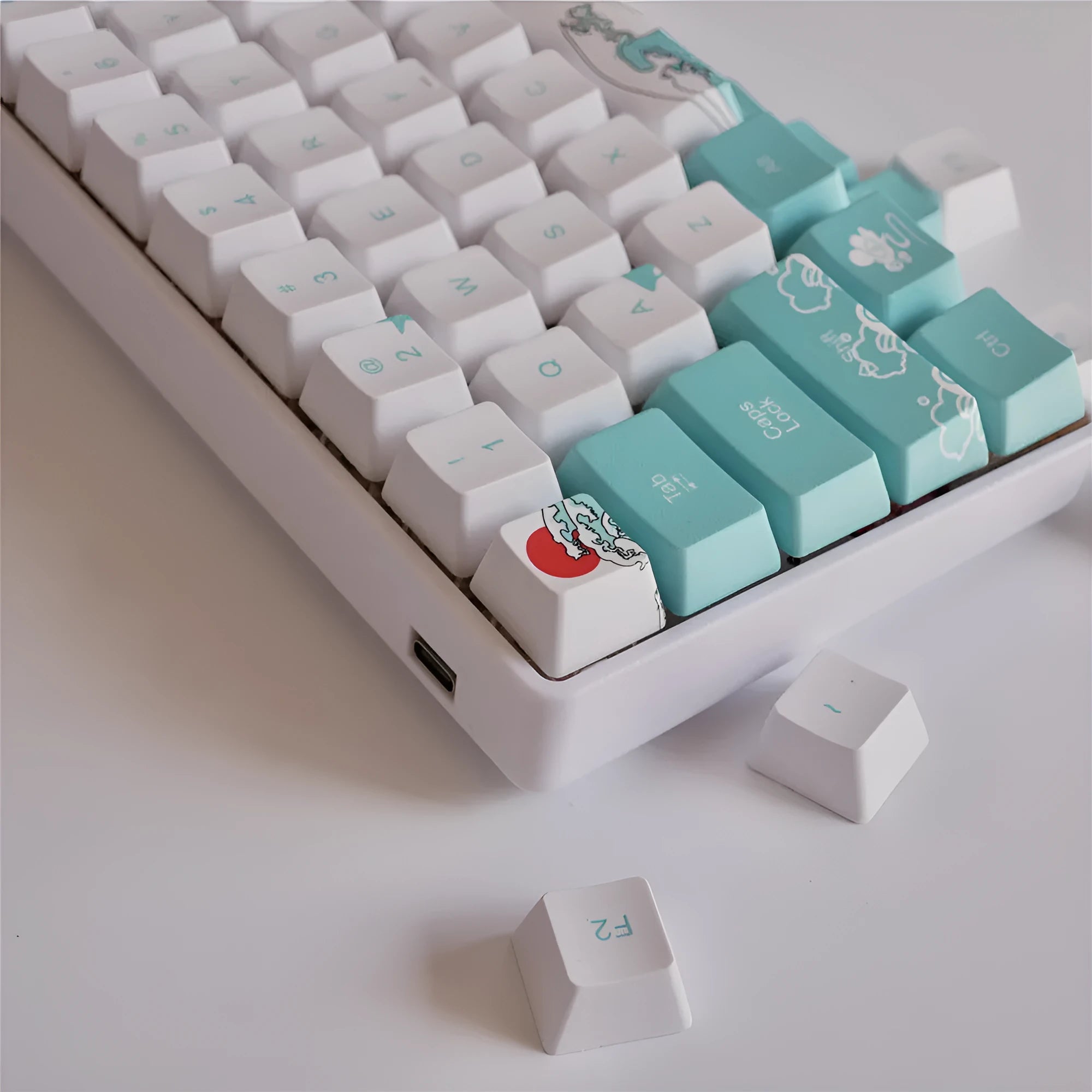 Coral Sea 108 keycap set for mechanical keyboard with blue gradient keys and multimedia legends on a white desk