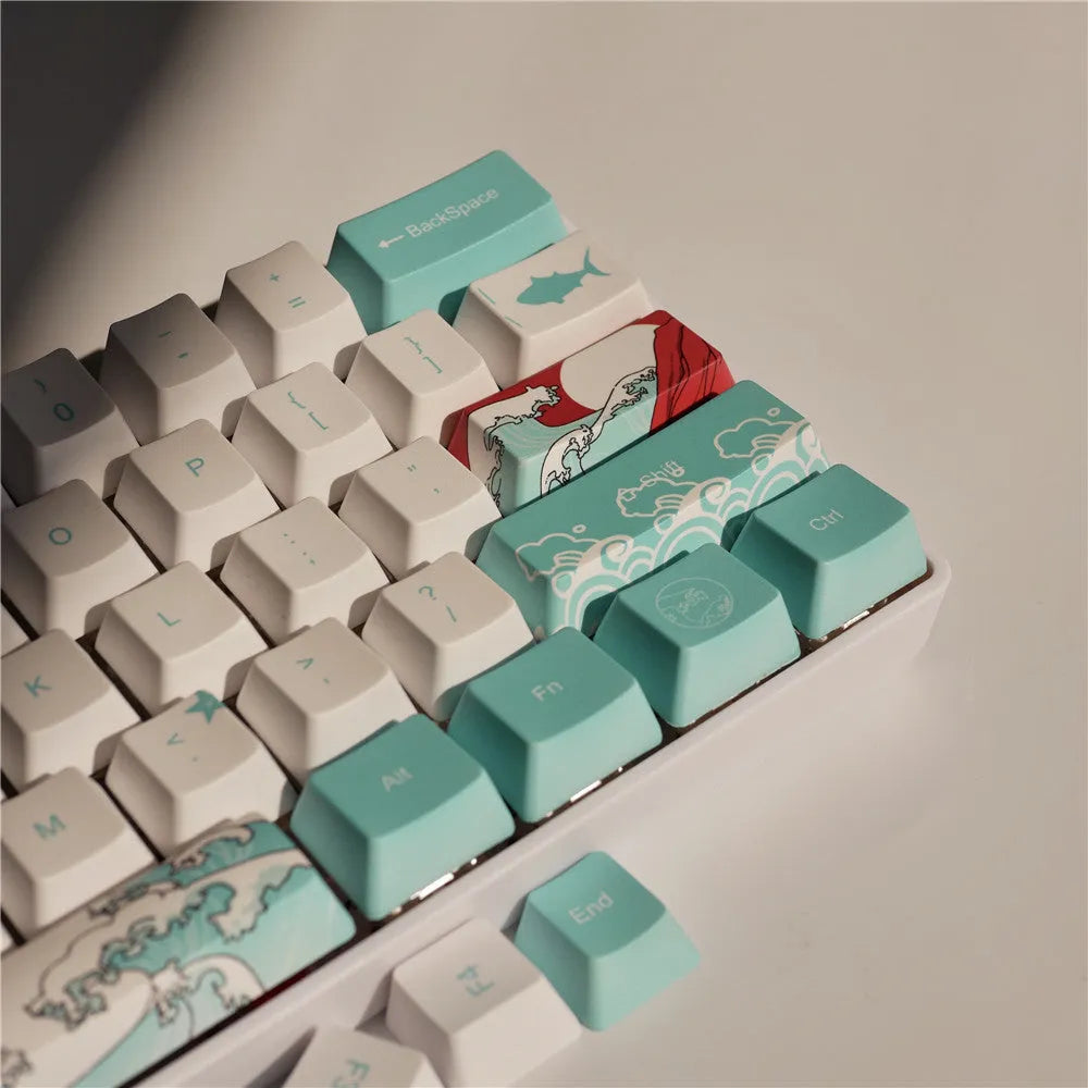 Coral Sea 108 keycap set for mechanical keyboard with blue gradient keys and multimedia legends on a white desk