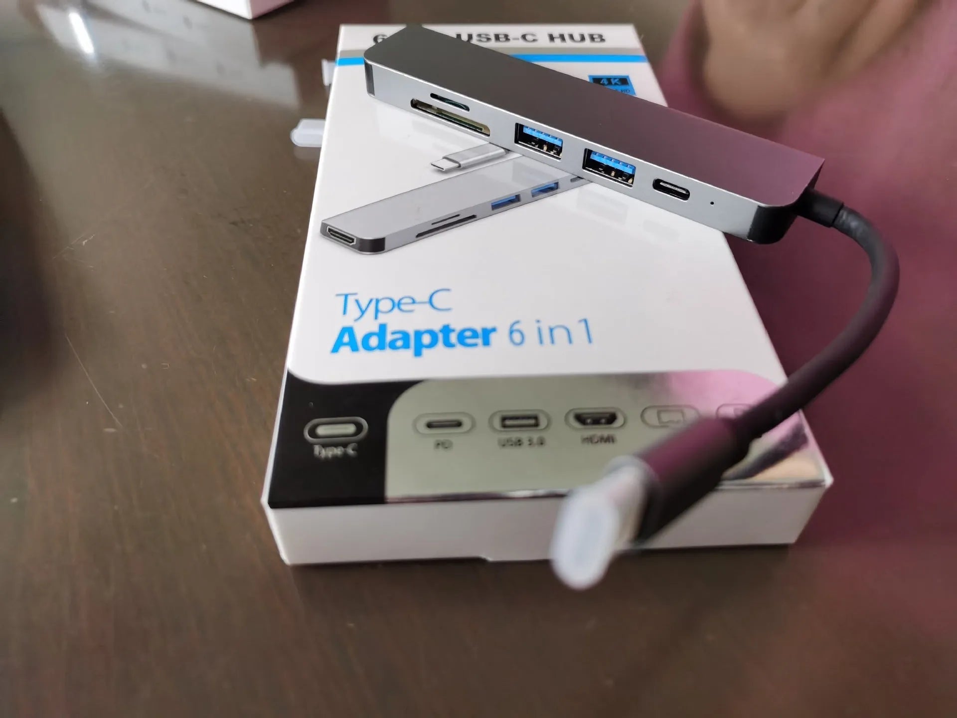 Silver 6 in 1 USB C hub adapter with USB ports, SD/TF slots, HDMI, and PD charging port