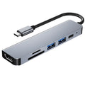 Silver 6 in 1 USB C hub adapter with USB ports, SD/TF slots, HDMI, and PD charging port