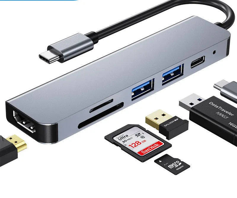 Silver 6 in 1 USB C hub adapter with USB ports, SD/TF slots, HDMI, and PD charging port