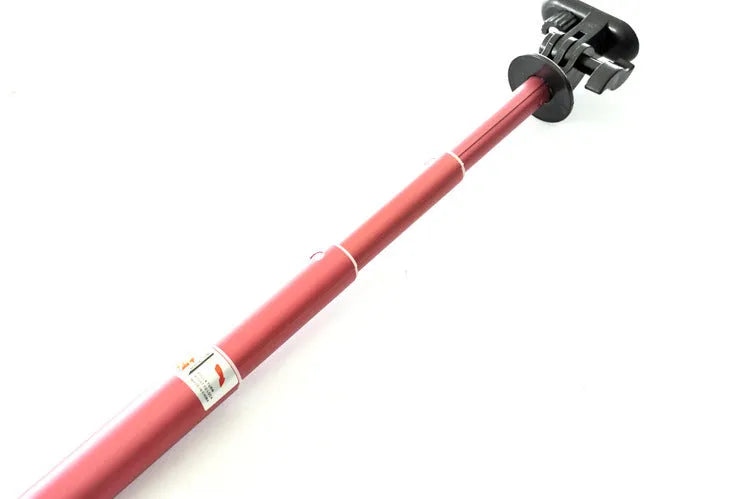 Aluminium alloy extendable selfie stick for mobile phones in black, red, and gold colours with a remote control.