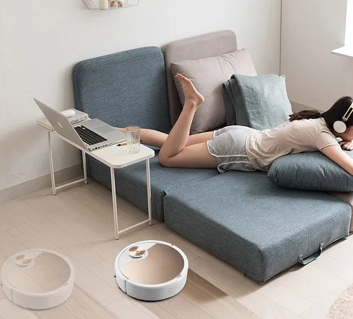 Golden and silver robot vacuum cleaner with remote control measuring 300mm square