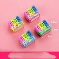 Set of four colourful cartoon book-shaped erasers for student prizes and gifts.