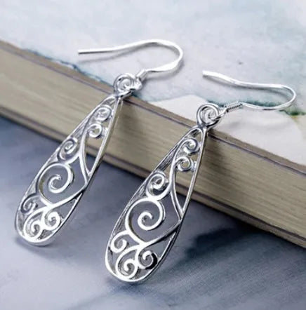 White carved drop shape stud earrings in platinum colour made from environmentally friendly copper
