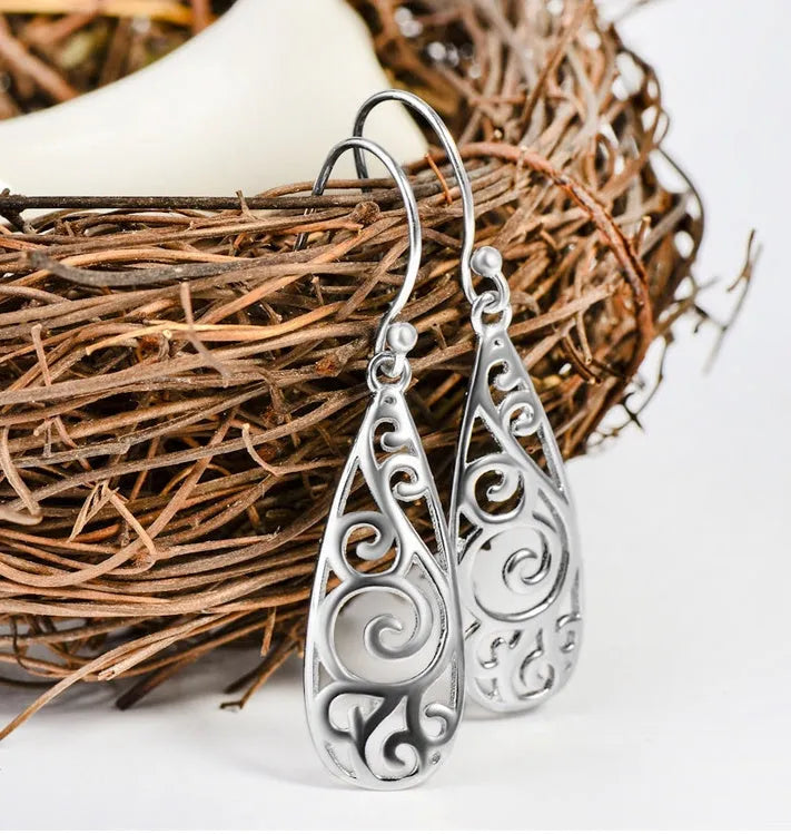 White carved drop shape stud earrings in platinum colour made from environmentally friendly copper