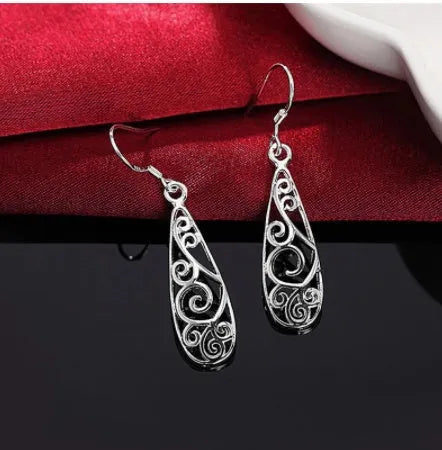 White carved drop shape stud earrings in platinum colour made from environmentally friendly copper