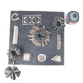 Grey cloth pet sniffing pad with two snuffle toys on a surface, designed for dog foraging and stress relief