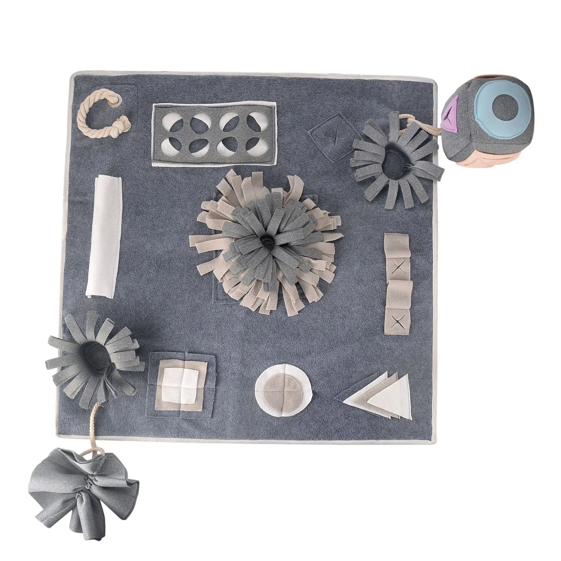 Grey cloth pet sniffing pad with two snuffle toys on a surface, designed for dog foraging and stress relief