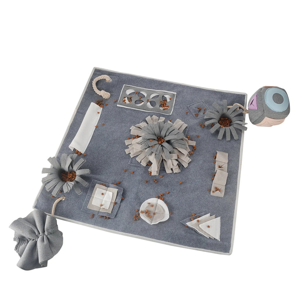 Grey cloth pet sniffing pad with two snuffle toys on a surface, designed for dog foraging and stress relief