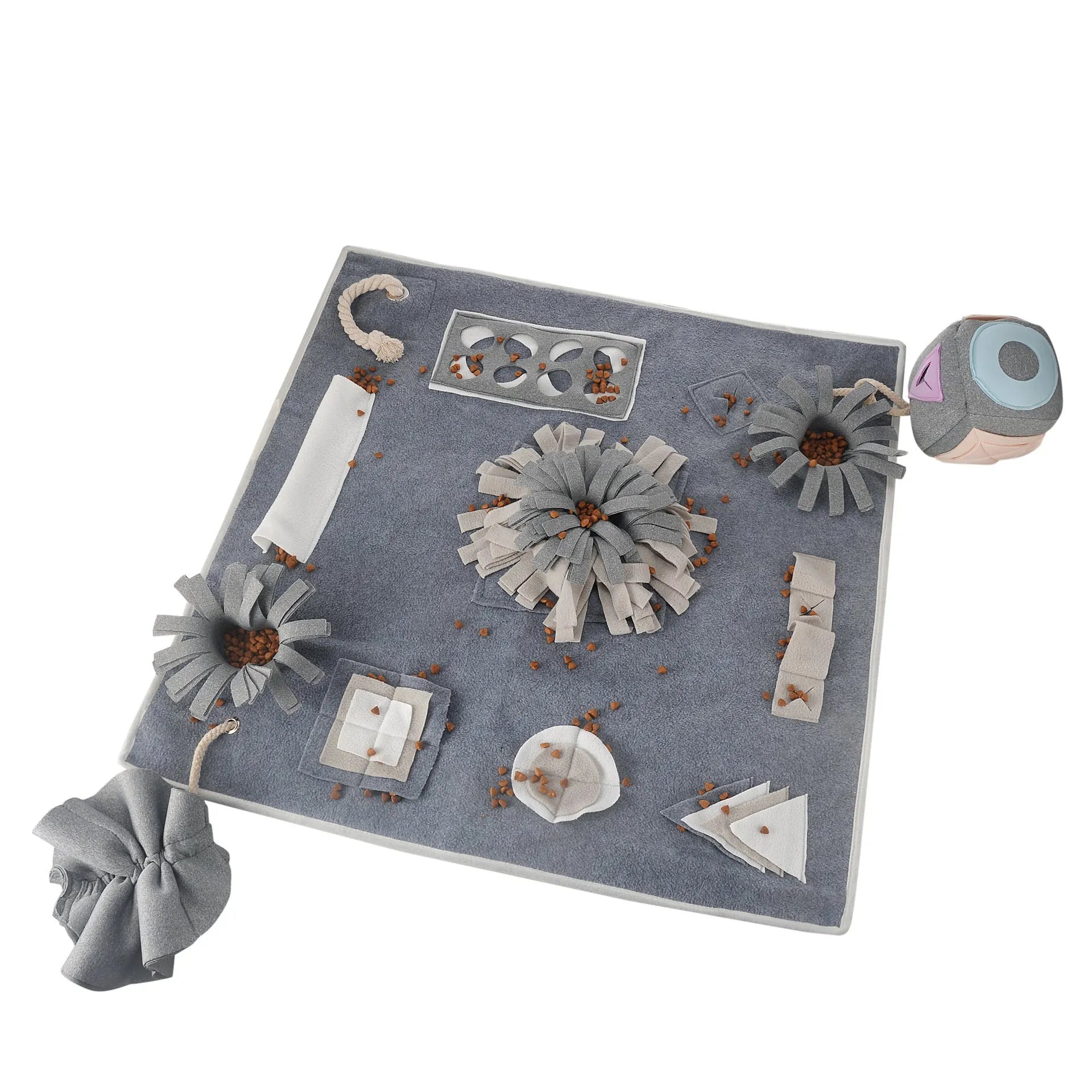 Grey cloth pet sniffing pad with two snuffle toys on a surface, designed for dog foraging and stress relief